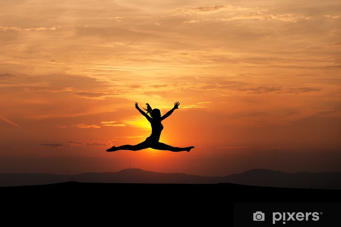 the splits by female gymnast in sunset